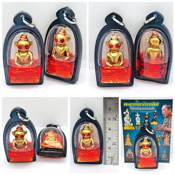 Thai charm amulet for luck featuring gold and red decorative elements in a protective casing