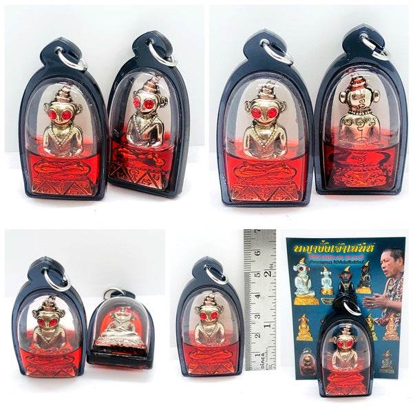 Thai charm amulet for luck in protective casing, featuring intricate design and vibrant colors