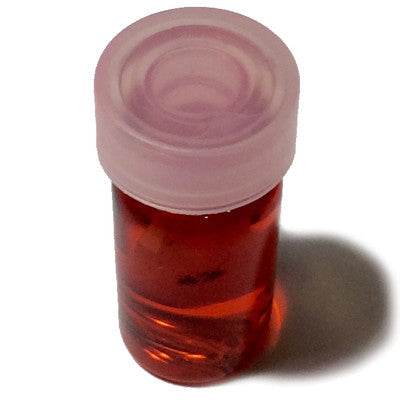 Thai charm oil for luck and popularity in a small transparent bottle with a pink cap