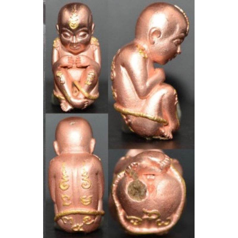 Thai child spirit for good luck statue with detailed craftsmanship and gold accents on a dark background