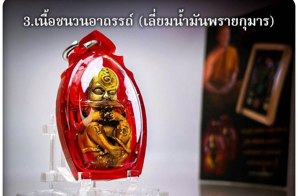 Thai child spirit for good luck in a protective red casing, symbolizing fortune and blessings.