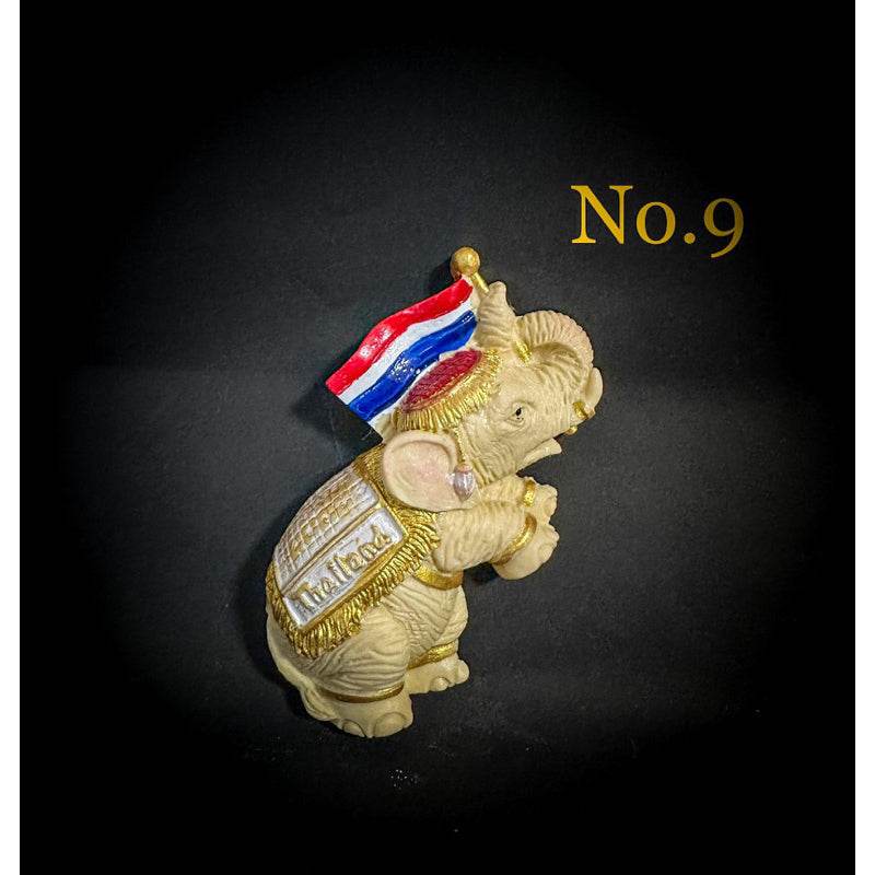 Thai elephant fridge magnet with detailed decorations holding a Thai flag from One-Sake.com