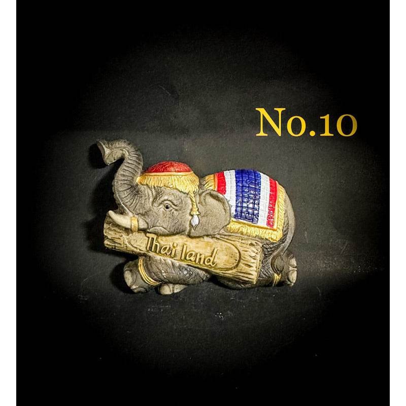 Thai elephant fridge magnet with colorful blanket holding a Thailand sign souvenir