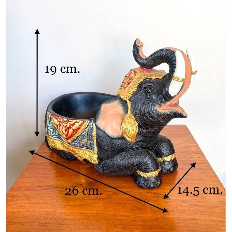 Thai elephant resin tray with intricate gold and blue decorations measuring 26 cm long on a wooden table
