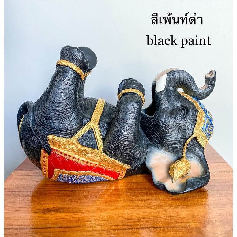 Black paint Thai elephant wine rack lying on its back with decorative gold and red details