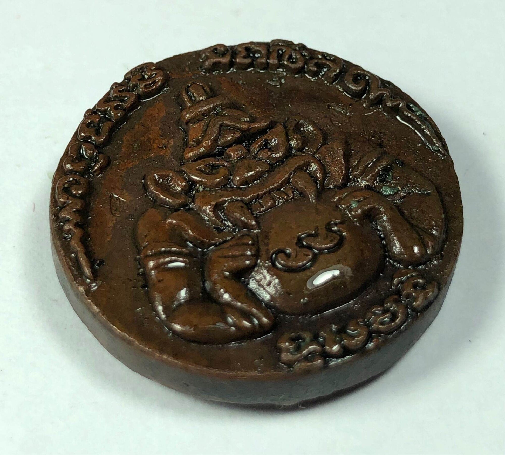 First Edition Rahu Amulet bronze medallion showing seated Rahu deity with intricate Thai script edge