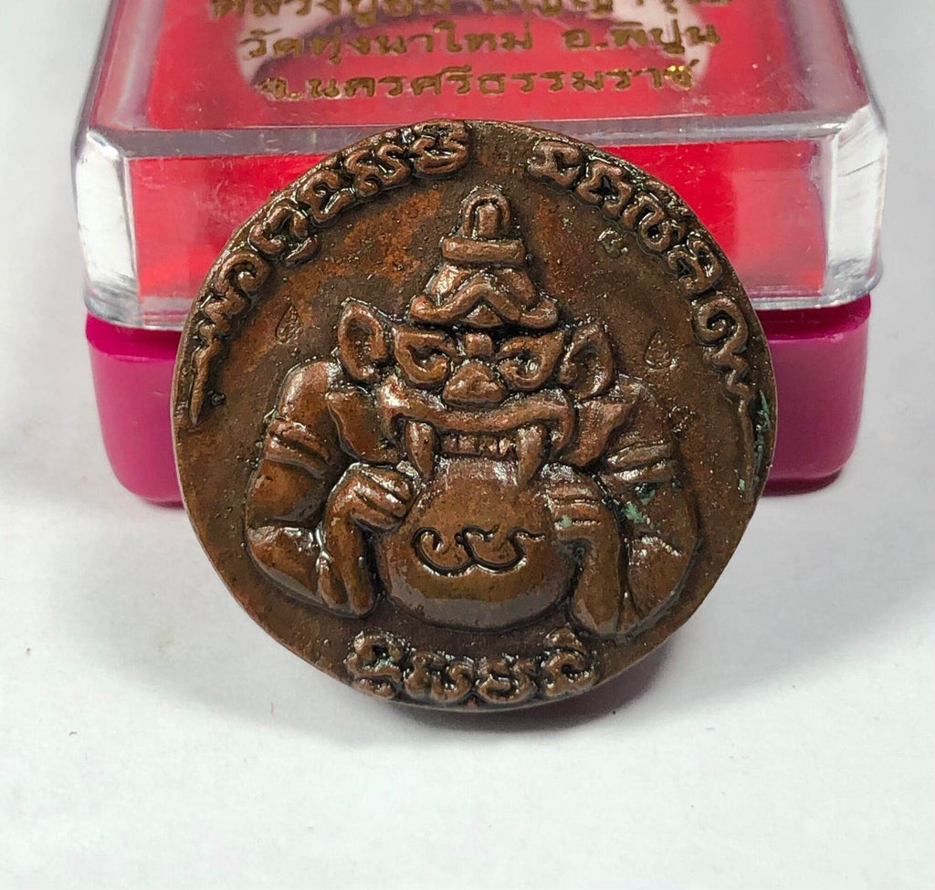 First Edition Rahu Amulet bronze round talisman showing demon holding bowl with Thai script and plastic display box