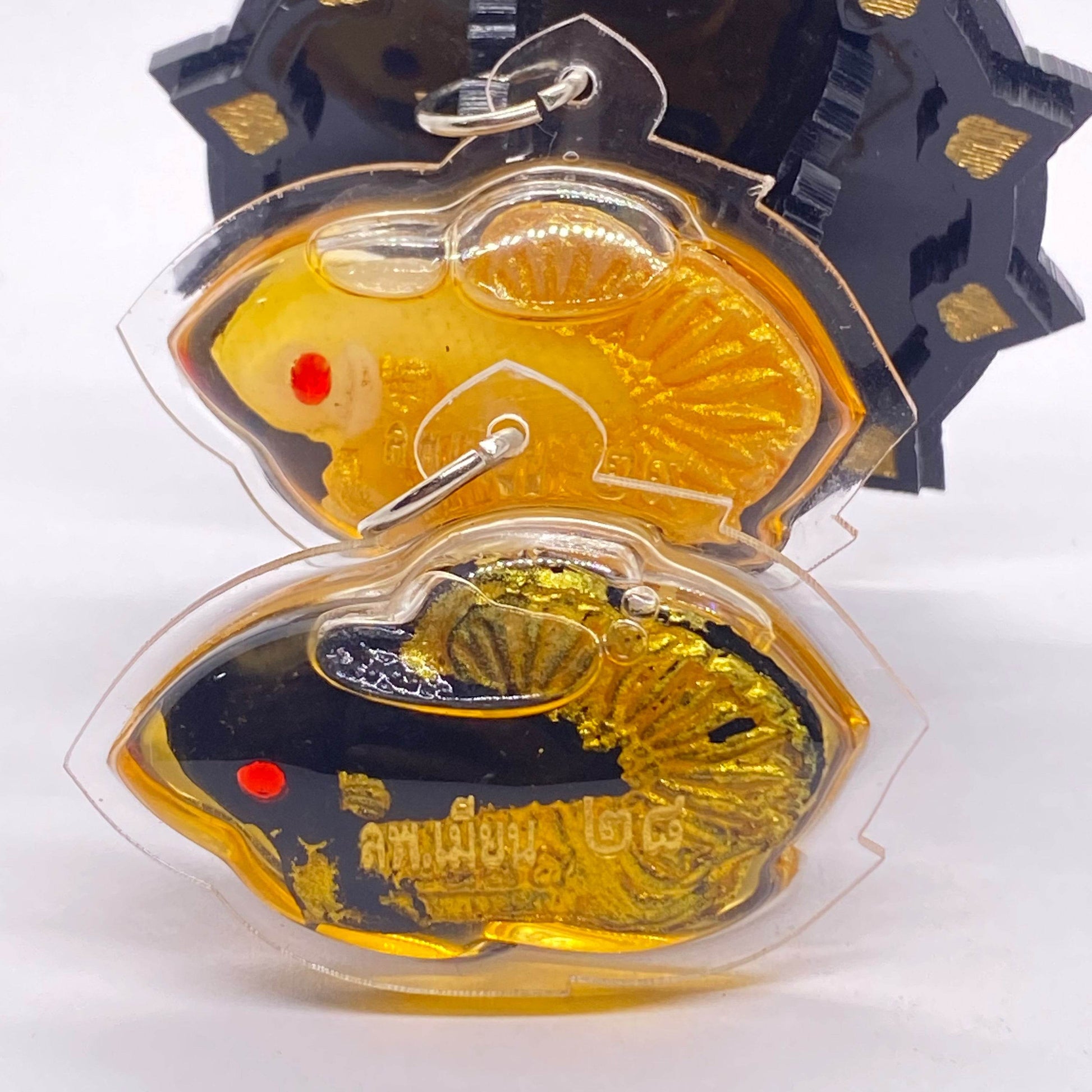 Thai fish amulet for protection and luck displayed with vibrant colors and detailed craftsmanship