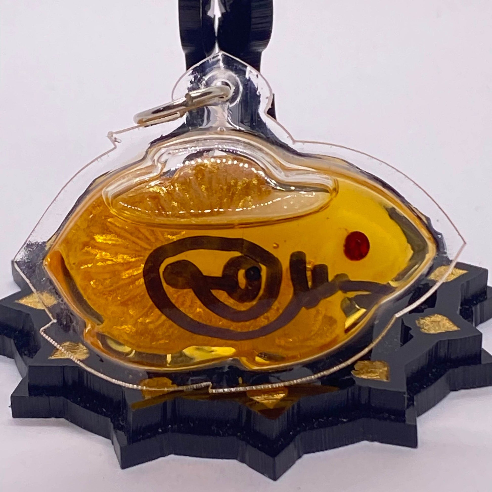 Thai fish amulet for protection and luck in vibrant resin with sacred symbols for spiritual decor