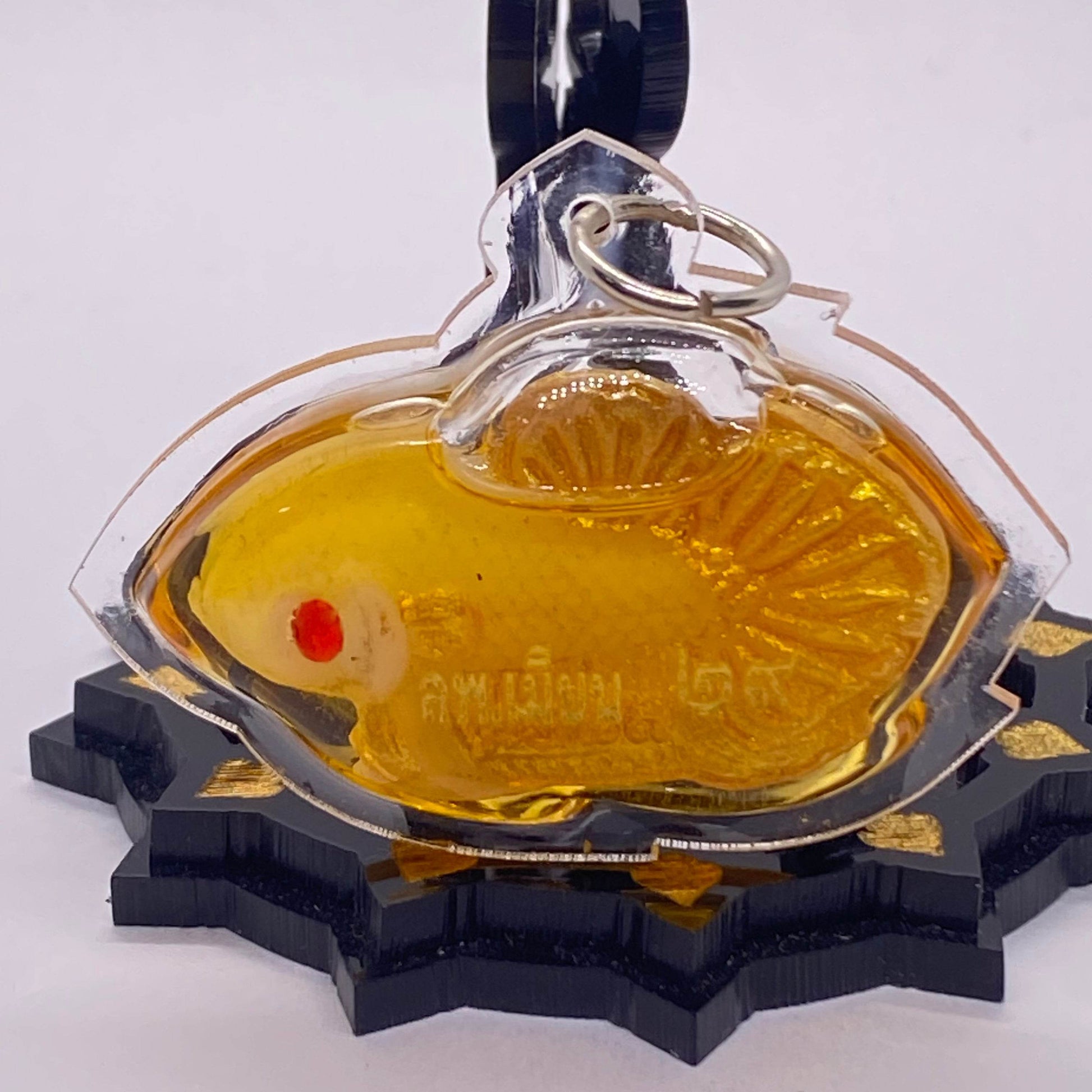Thai fish amulet for protection and luck in gold color with red accents and detailed design