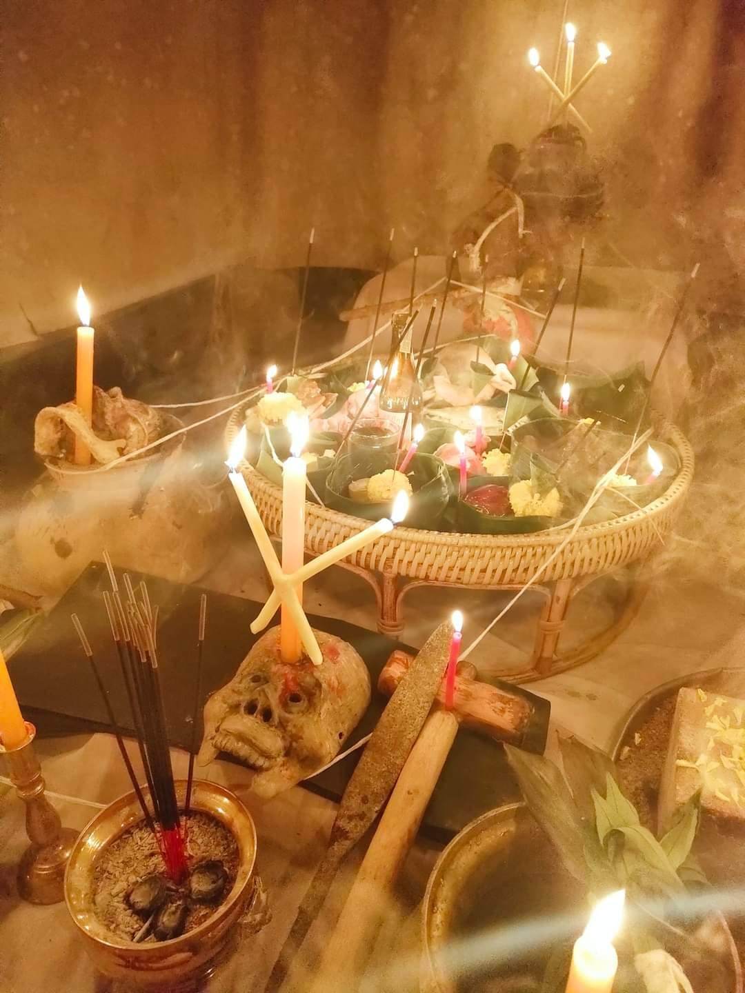 Spiritual altar with glowing candles and incense featuring a Thai gambler's takrud amulet ritual setup