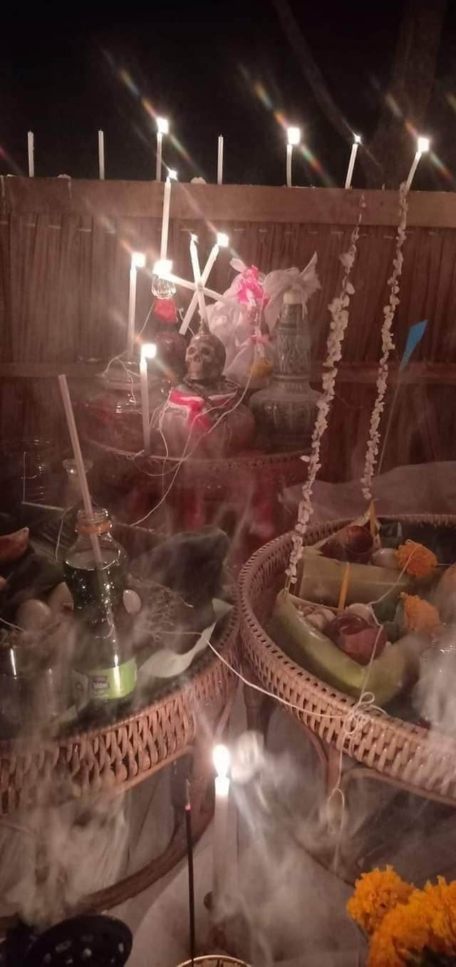Thai gambler's takrud amulet displayed in a traditional setting with candles and ritual items at night