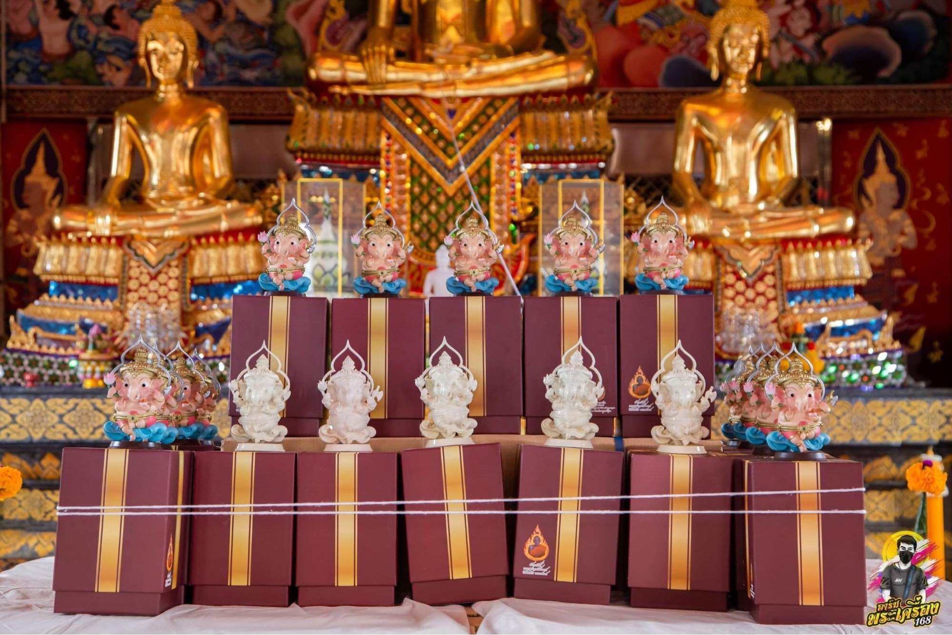 Collection of Thai Ganesha amulets for wealth displayed in elegant boxes at a temple