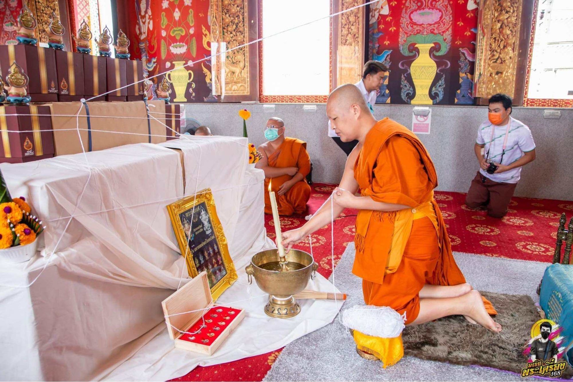 Thai Ganesha amulet for wealth displayed during a spiritual blessing ceremony by monks
