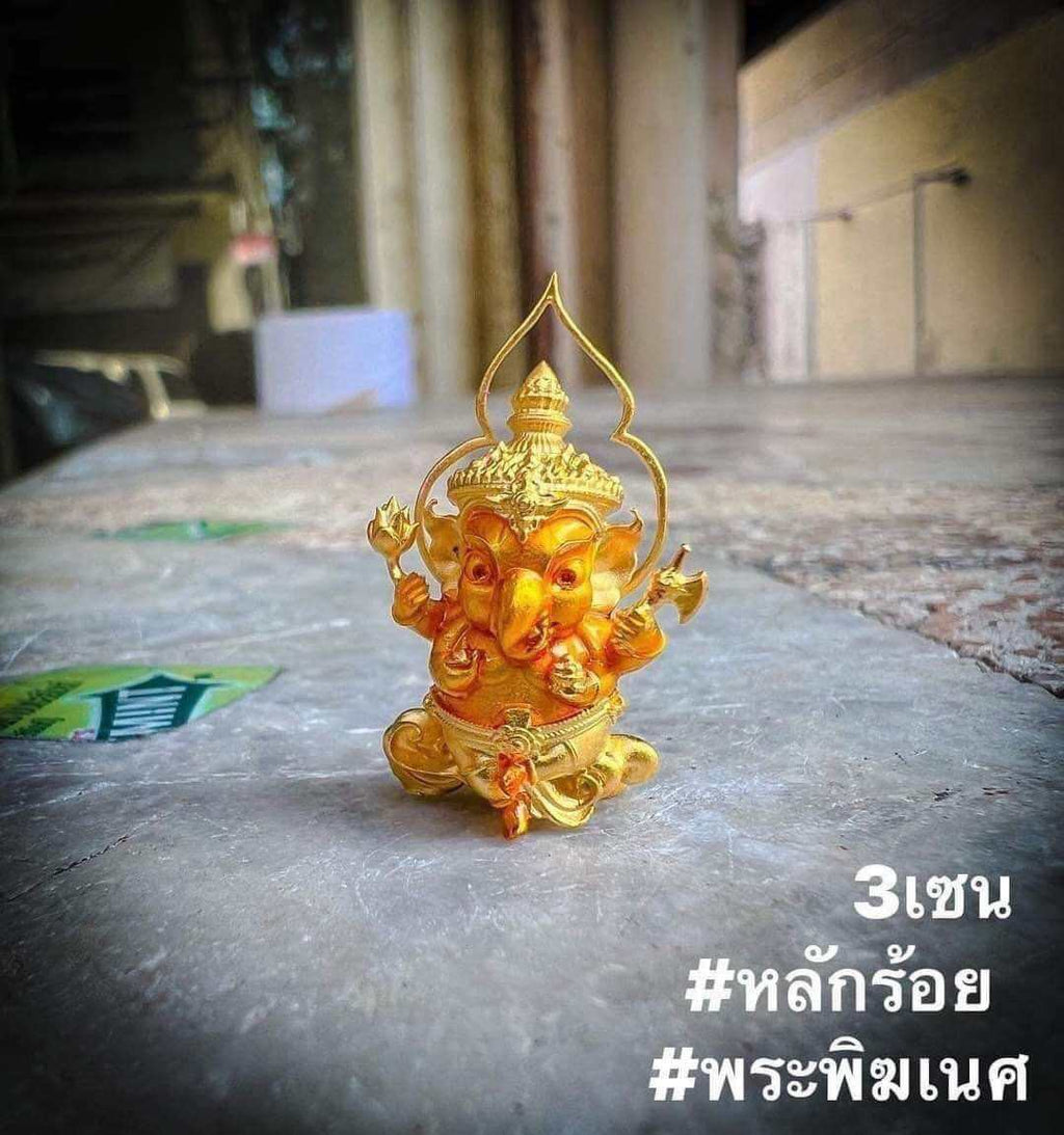 Thai Ganesha amulet for wealth, intricately designed in gold color, symbolizing prosperity and good fortune