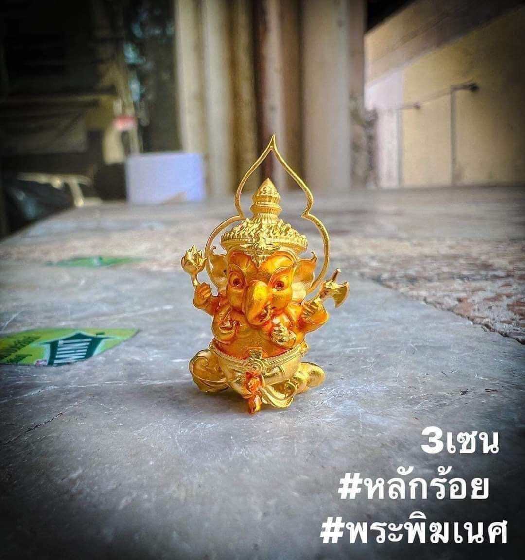 Thai Ganesha amulet for wealth, intricately designed in gold color, symbolizing prosperity and good fortune