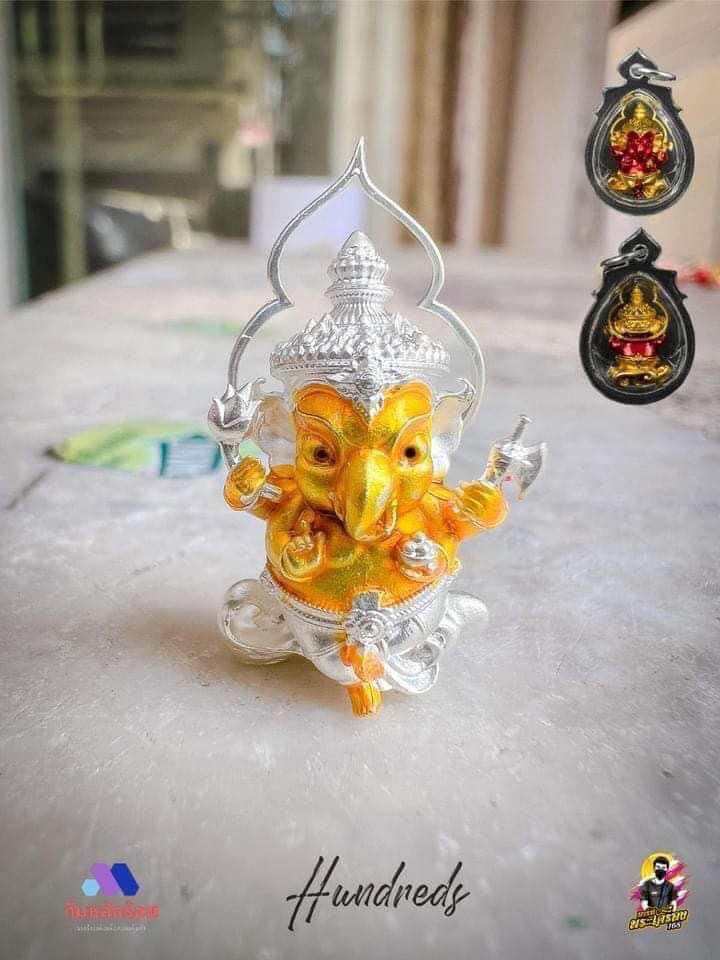 Thai Ganesha amulet for wealth carved in vibrant colors with intricate silver detailing