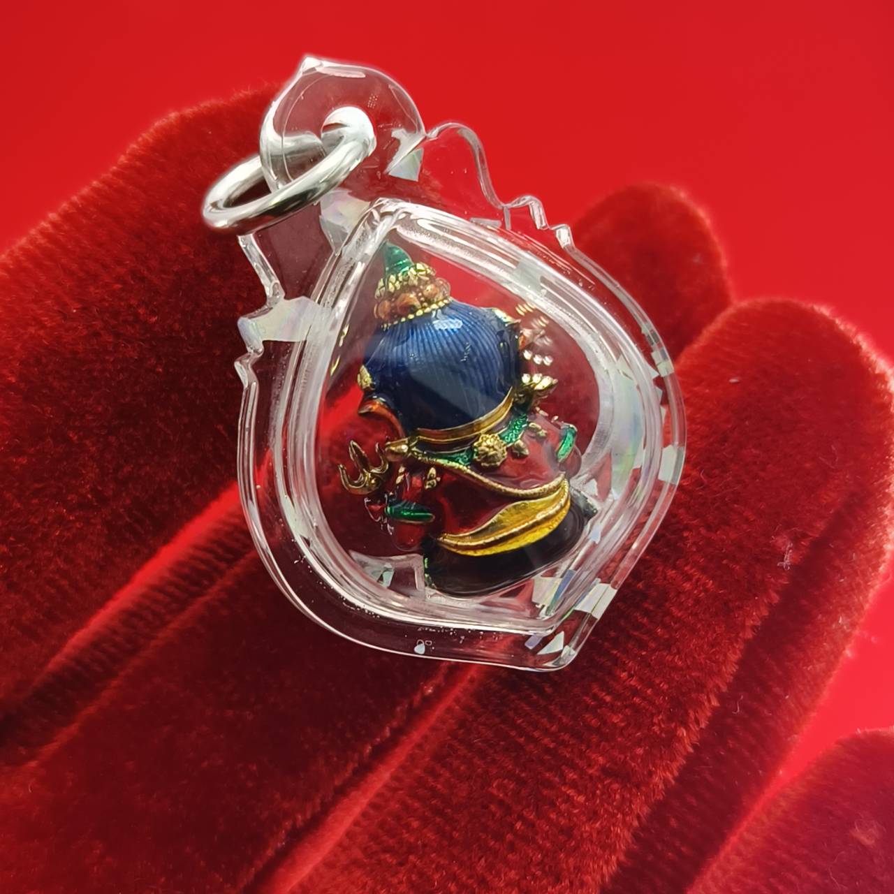 Thai Ganesha lucky charm pendant encased in clear protective plastic for spiritual blessings