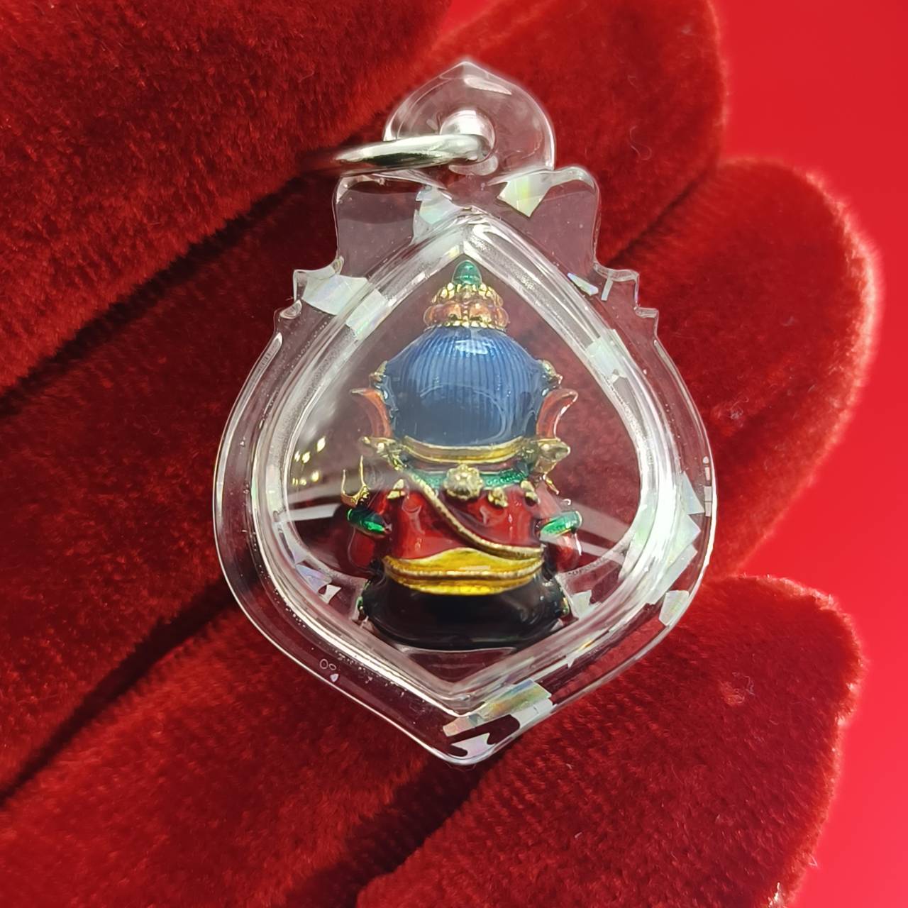 Thai Ganesha lucky charm pendant in a clear protective casing for home decor and spiritual use