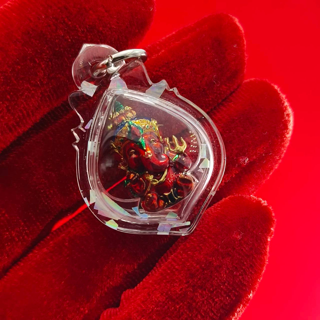 Thai Ganesha lucky charm pendant in clear protective casing, designed to bring good luck and positivity