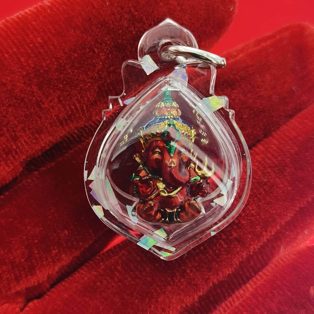 Thai Ganesha lucky charm pendant in a clear protective casing, featuring intricate details of Ganesha