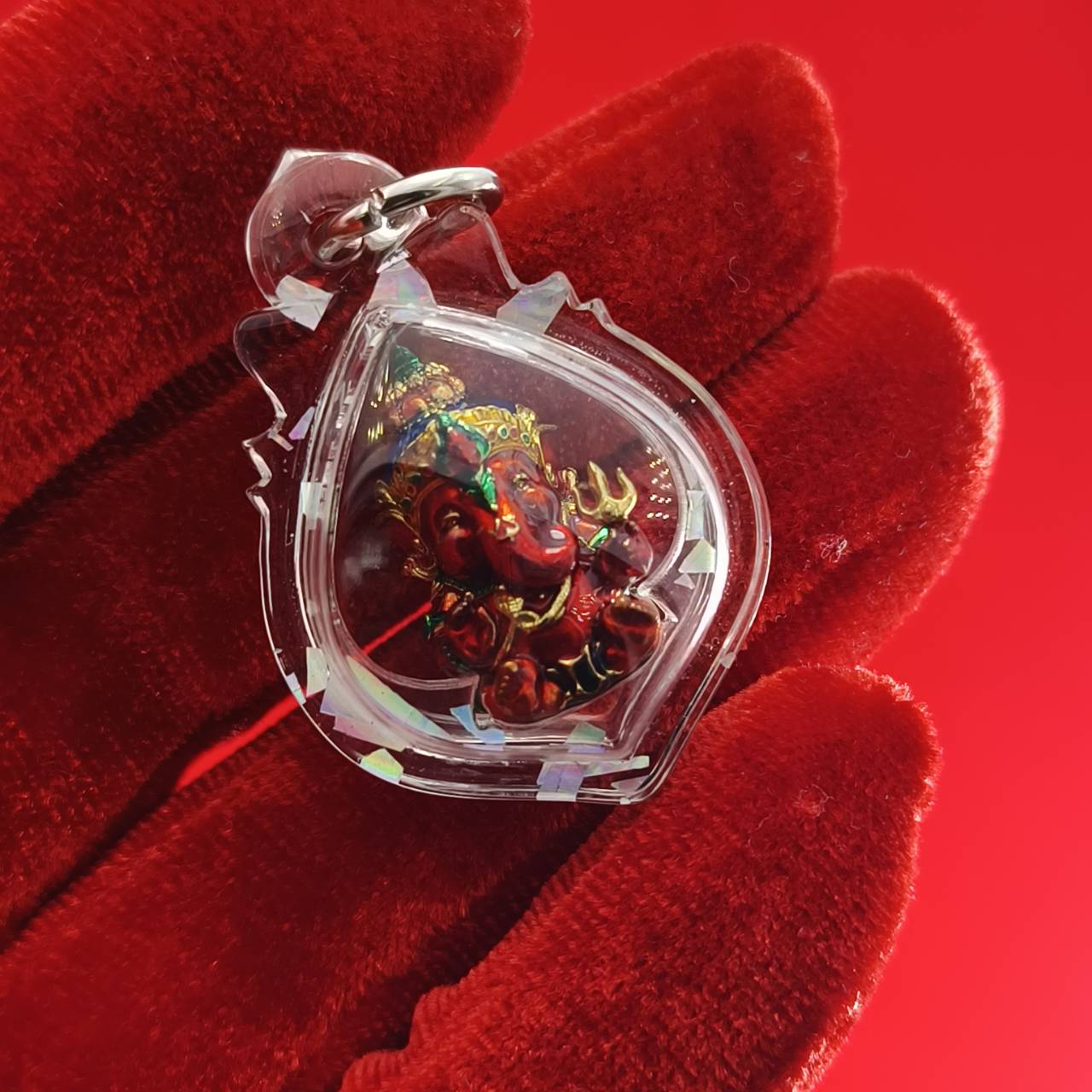 Thai Ganesha lucky charm pendant encased in a protective plastic cover for good fortune and blessings