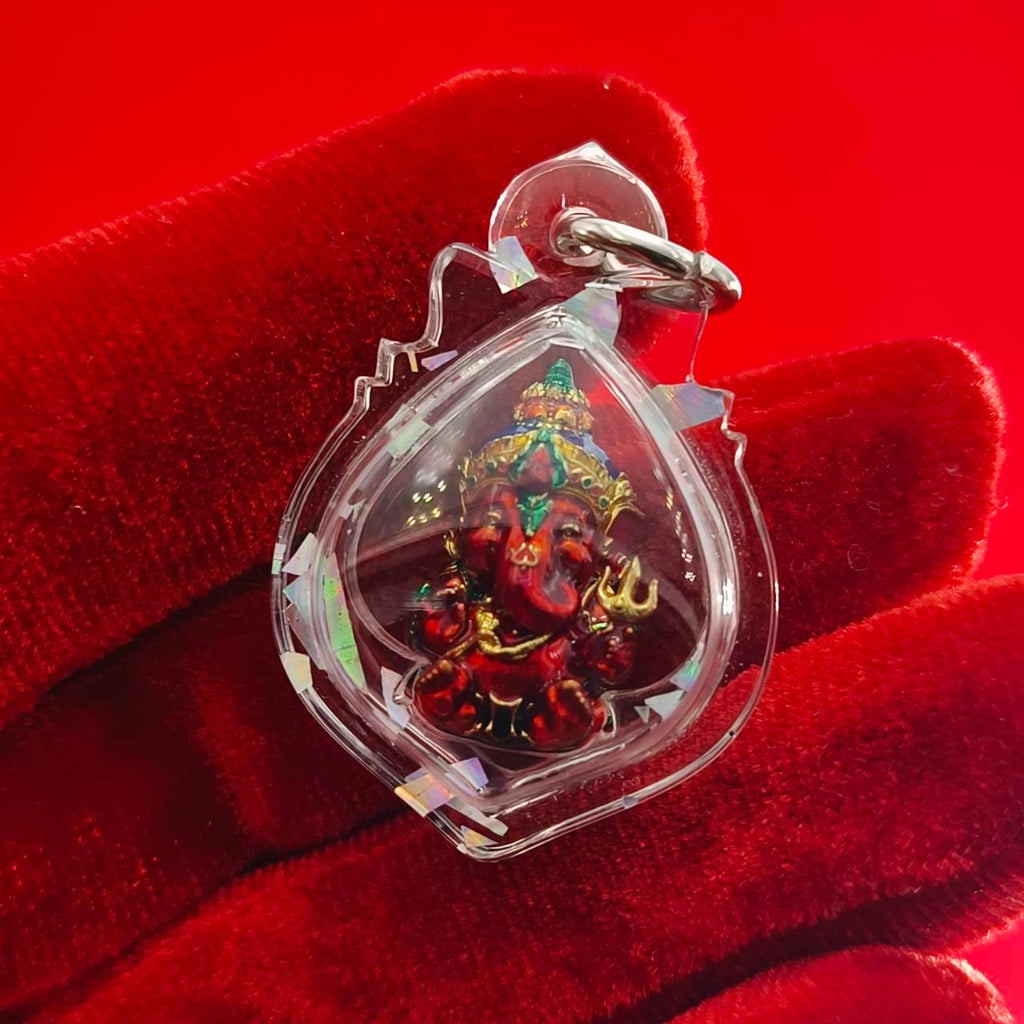 Thai Ganesha lucky charm pendant in a clear casing, featuring vibrant details of the Ganesha deity