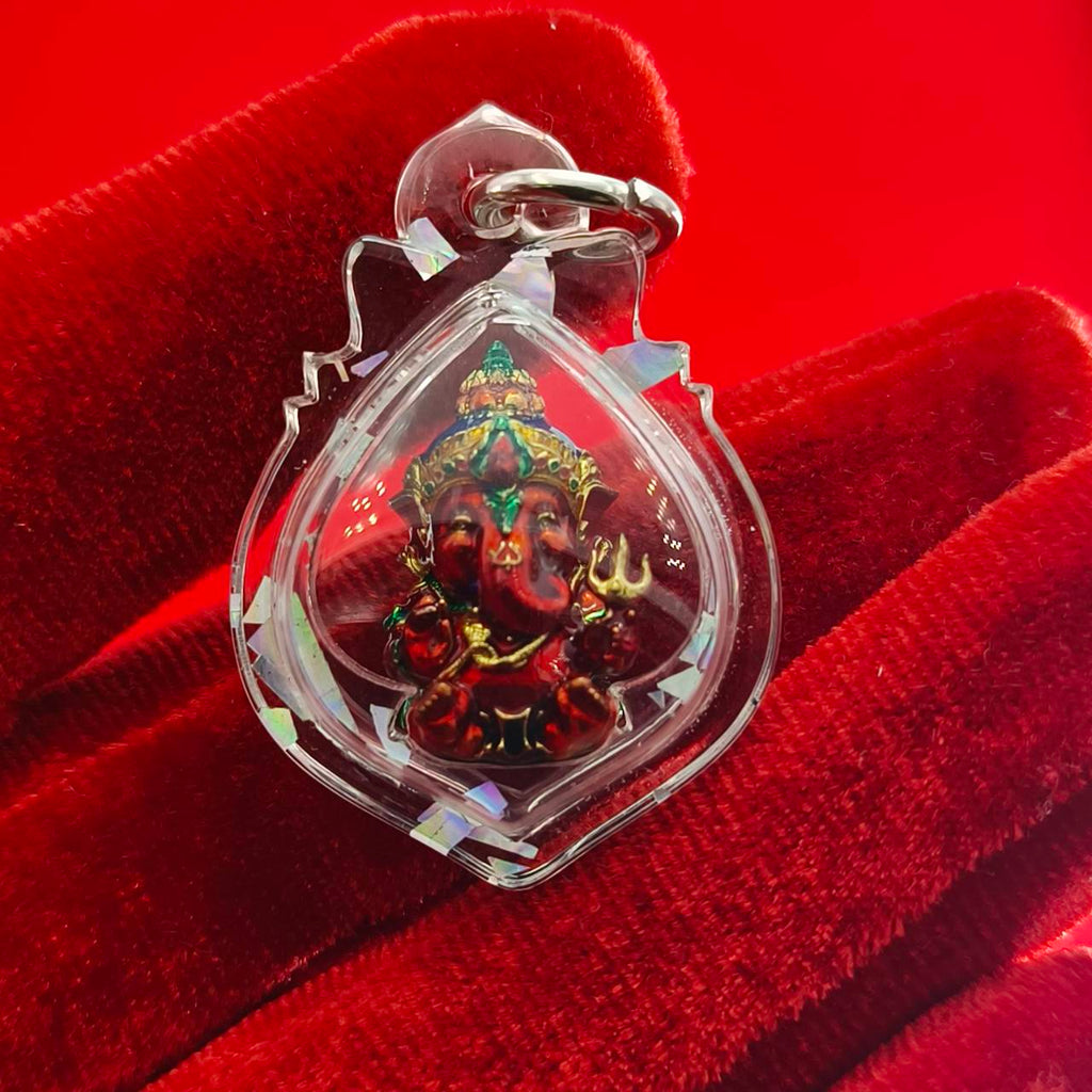 Thai Ganesha lucky charm pendant in clear casing with intricate detailing for spiritual protection