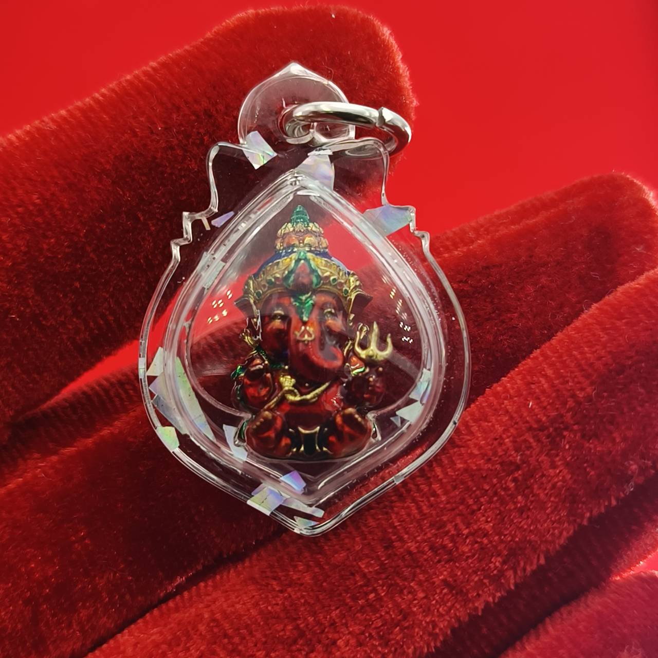 Thai Ganesha lucky charm pendant in clear casing with intricate detailing for spiritual protection