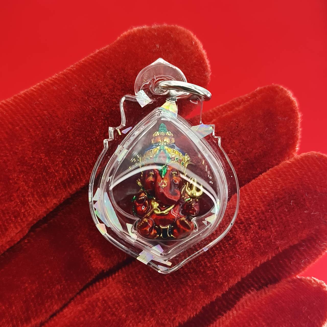 Thai Ganesha lucky charm pendant in clear case, featuring vibrant colors for home decor and spiritual beliefs