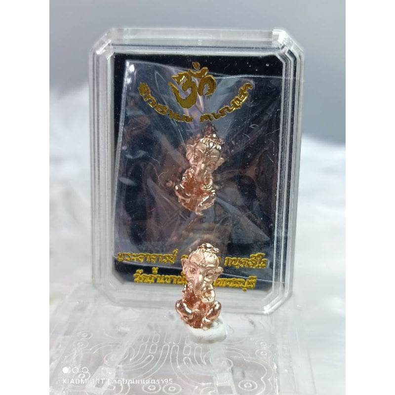 Thai ganesha miniature charm in copper color displayed in clear plastic protective case
