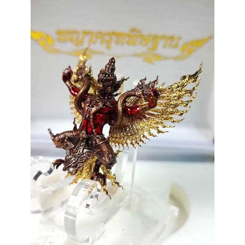 Intricate Thai Garuda lucky charm figurine with detailed gold wings and red accented body