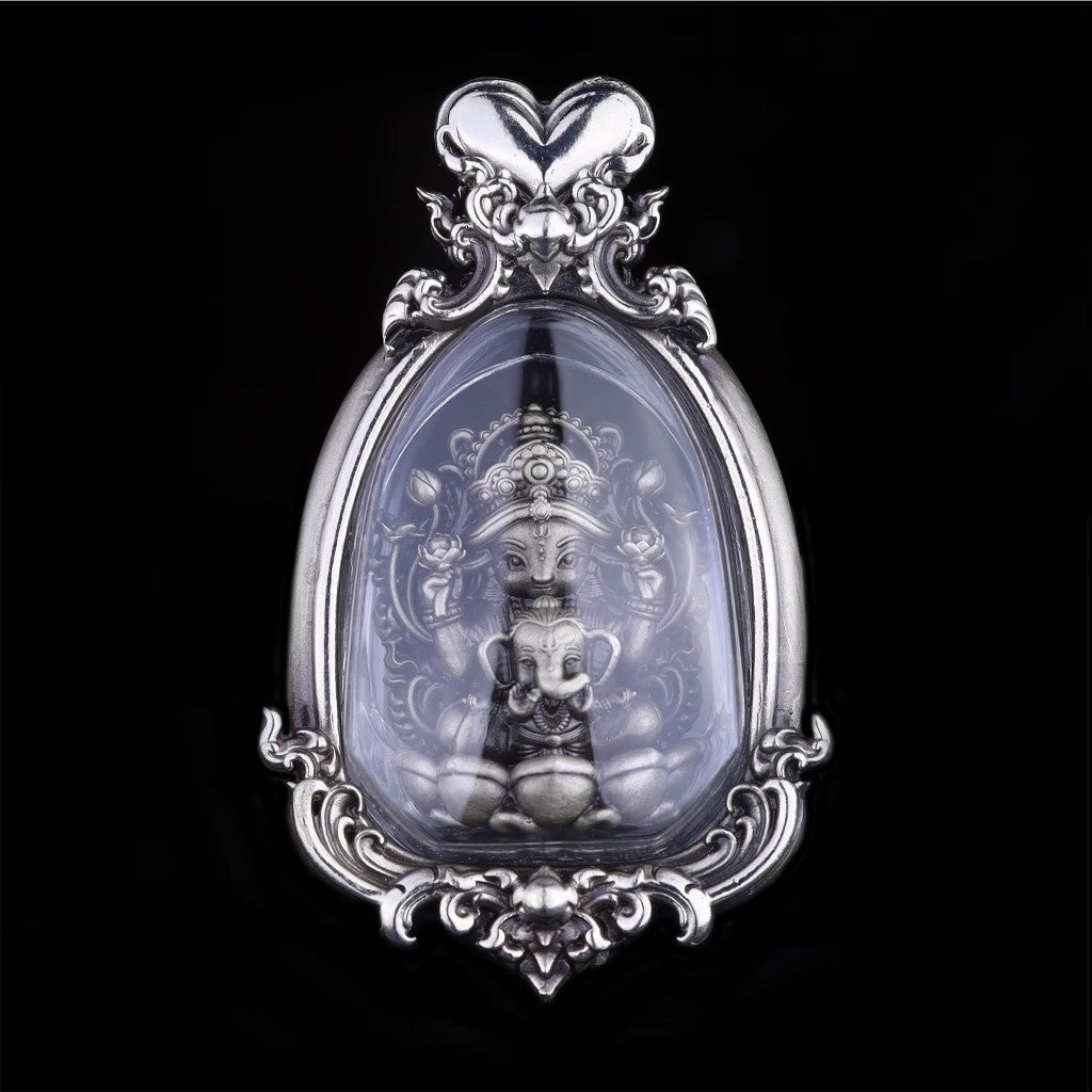 Intricate Thai goddess amulet for prosperity in ornate silver frame, symbolizing luck and abundance