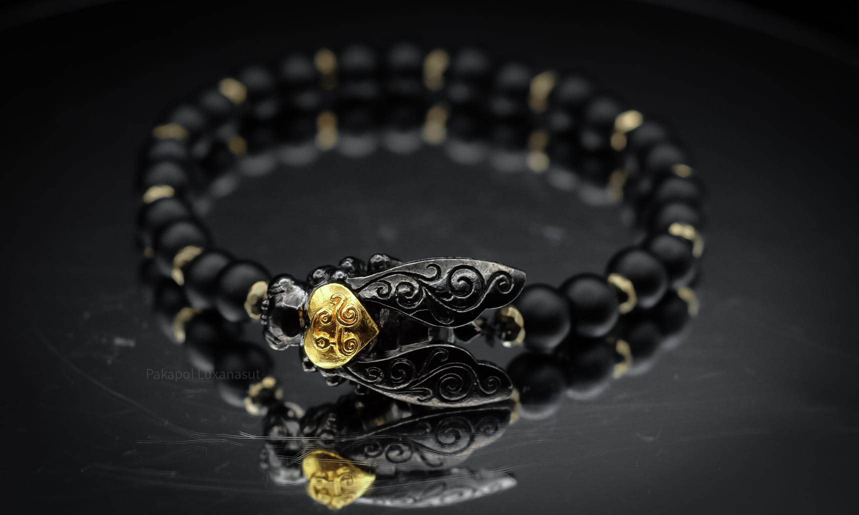 Thai golden bee amulet for wealth black bead bracelet with intricate gold and black detailing