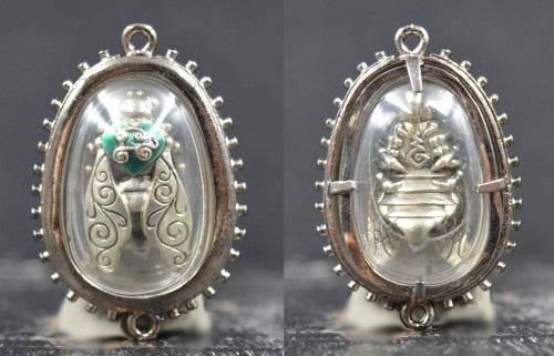 Thai golden bee amulet for wealth in clear oval case with detailed silver and gold design