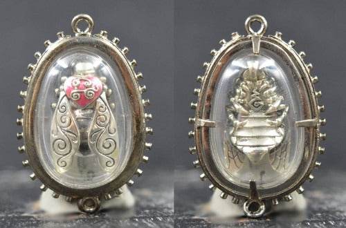 Thai golden bee amulet for wealth in oval silver casing with intricate wing and body details