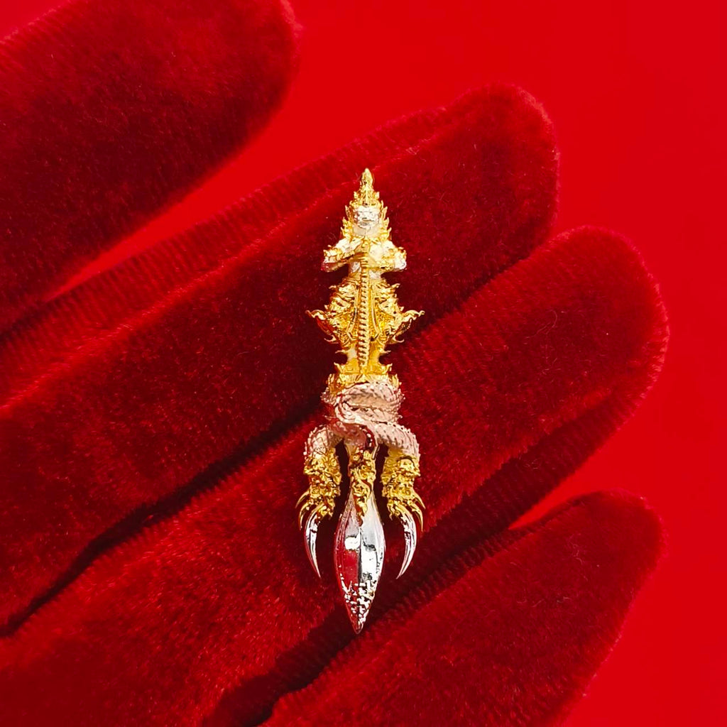 Thai guardian amulet Klang Setthi edition featuring intricate gold and silver detailing on a red background