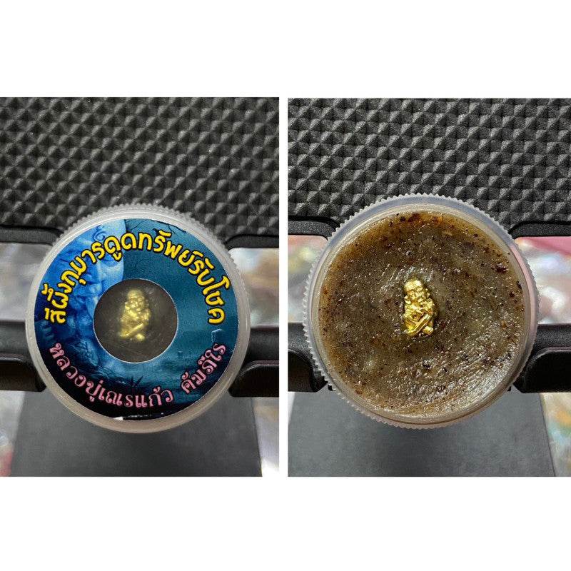 Thai Kuman Thong wealth charm in a decorative container for attracting prosperity and good fortune