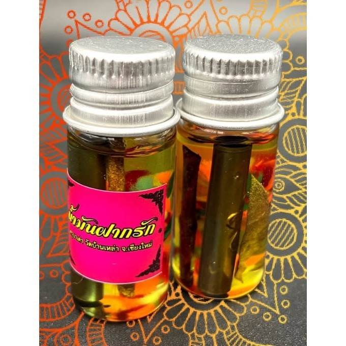 Thai love oil amulet in glass bottles with colorful herbal ingredients for attraction and good fortune