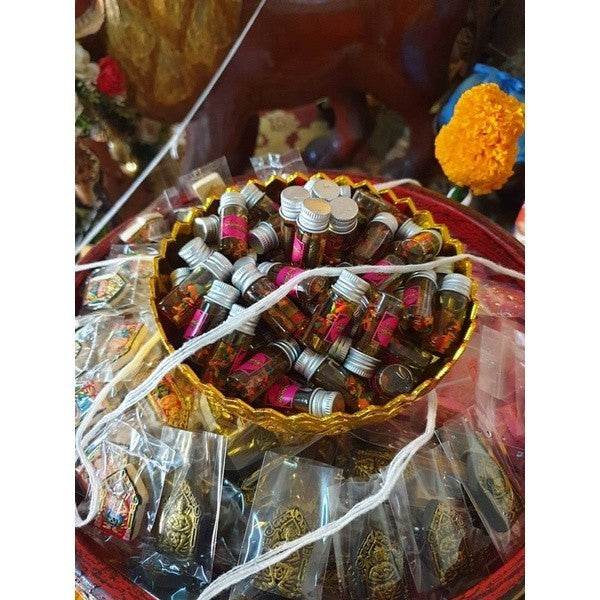 Collection of Thai love oil amulet in decorative bowl, ideal for enhancing love and relationships