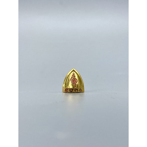 Small gold Thai luck amulet for victory with red inscriptions from Thai Blessing Co