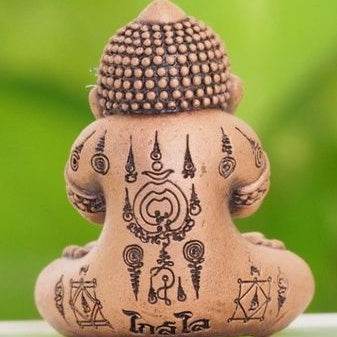 Thai lucky charm for prosperity clay figurine with traditional sacred symbols and intricate black markings