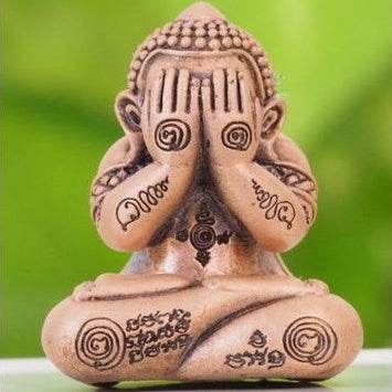 Thai lucky charm for prosperity featuring a seated statue with engraved sacred symbols