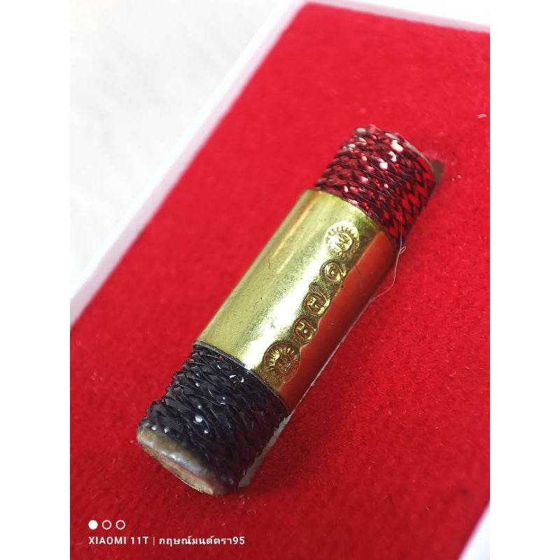 Thai lucky charm many wives with gold plate and red black threads on red background from Thai Blessing Co