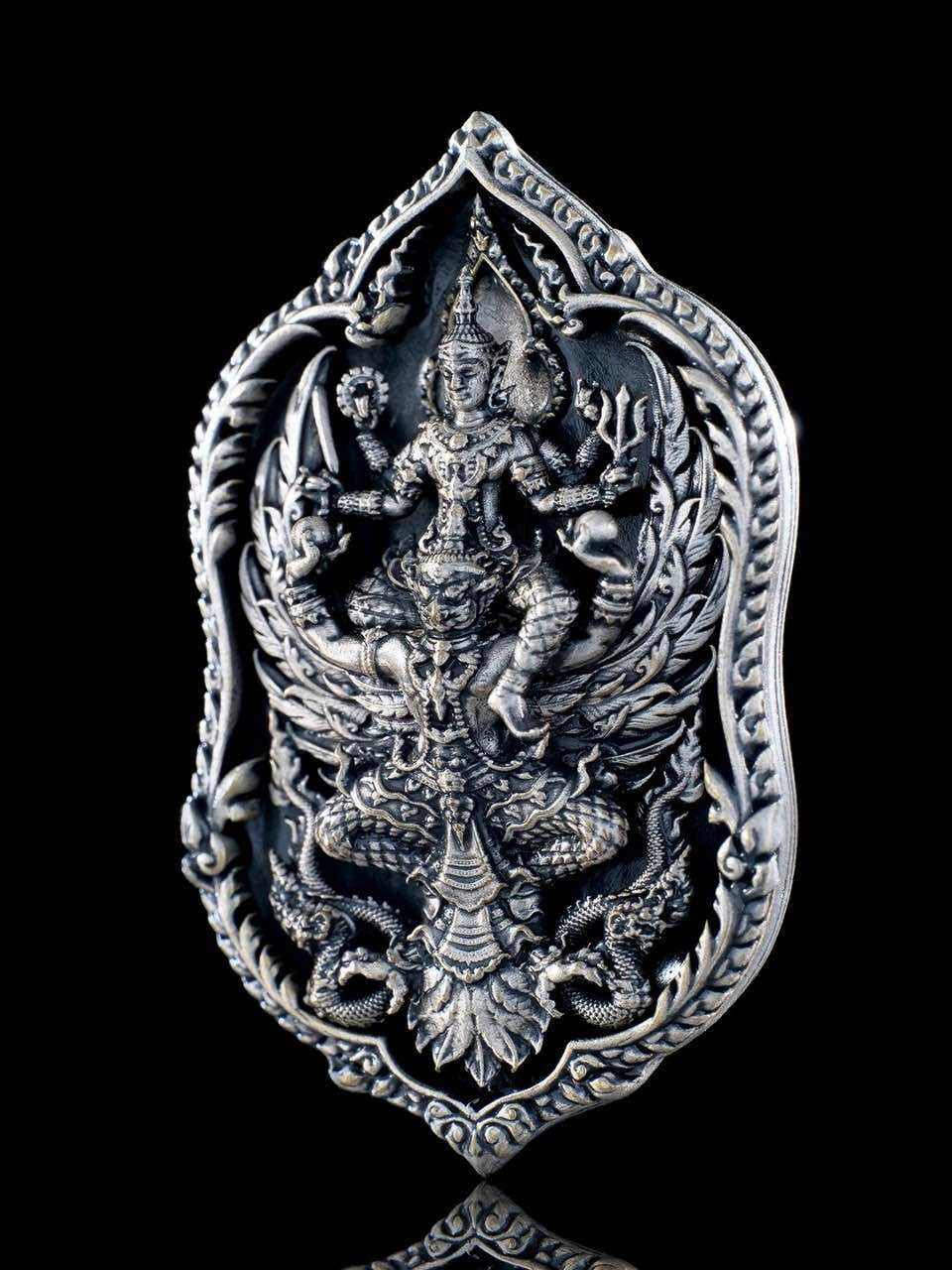 Engraved Thai lucky coin for wealth and protection featuring intricate deity design