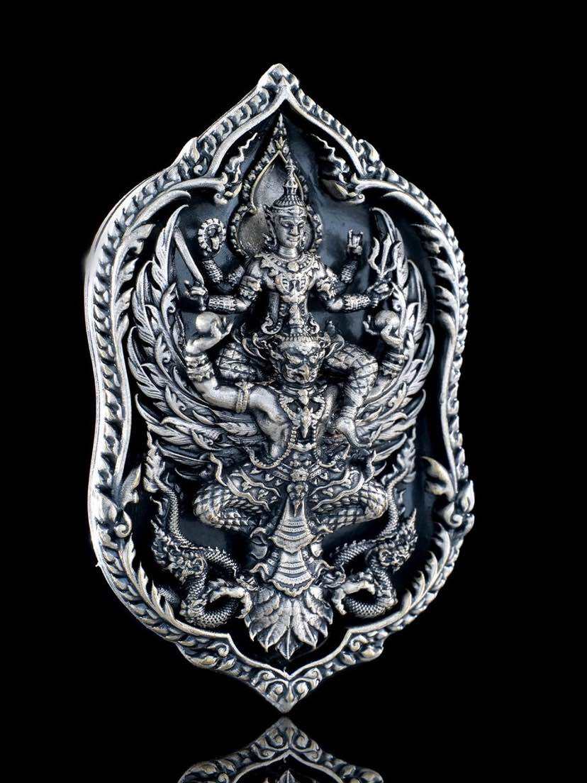 Intricate Thai lucky coin for wealth and protection featuring detailed deity design in silver finish