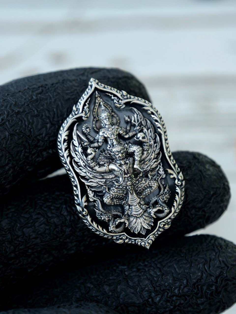 Intricate Thai lucky coin for wealth and protection featuring detailed deity design and silver finish