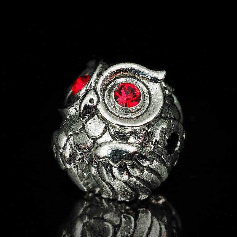 Silver Thai owl charm for luck and prosperity featuring red gemstone eyes, ideal for home decor
