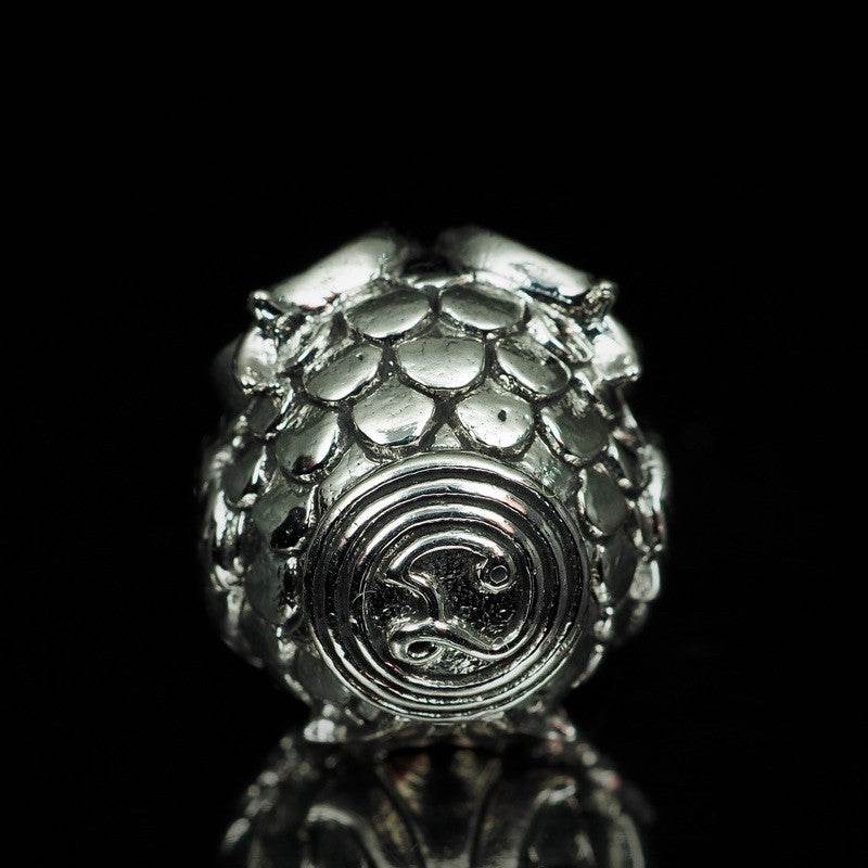 Thai owl charm for luck and prosperity made of shiny metal with intricate detailing
