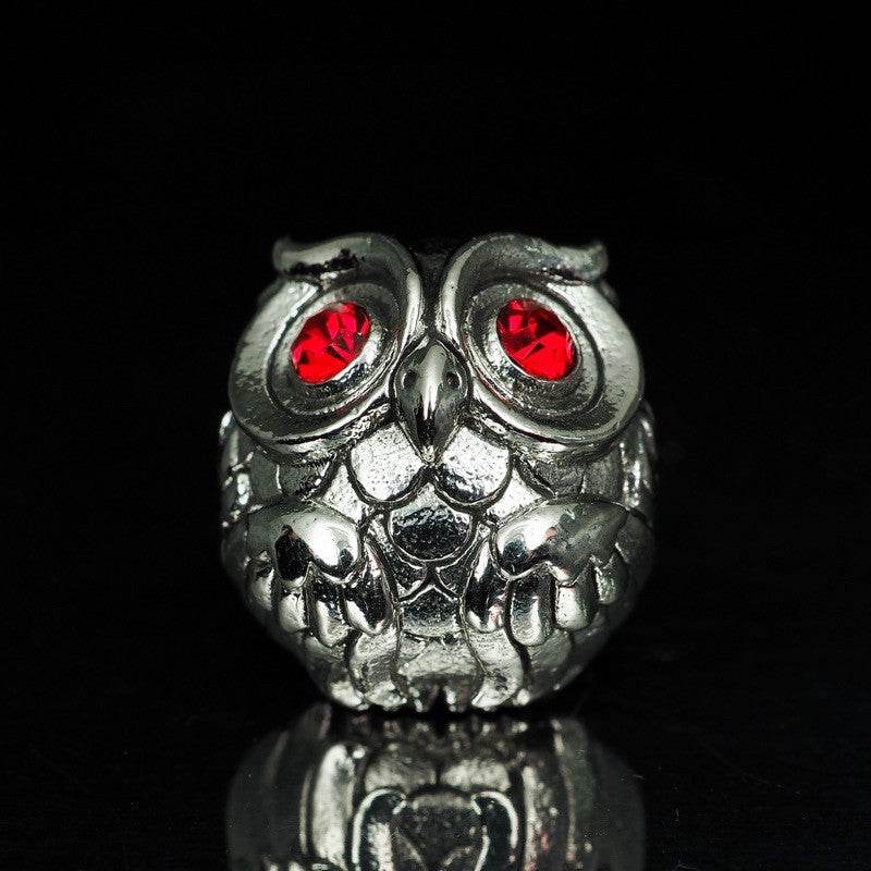 Thai owl charm for luck and prosperity with red gemstone eyes in a silver finish